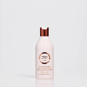 Bottle of Velvet Shampoo | OYA with sleek white and copper design on a neutral background, emphasizing luxury hair care and wellness product aesthetics.