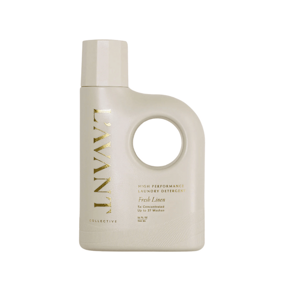 Minimalist beige bottle of High Performing Laundry Detergent - Fresh Linen | L'AVANT Collective with sleek gold lettering and ergonomic handle for easy pouring.