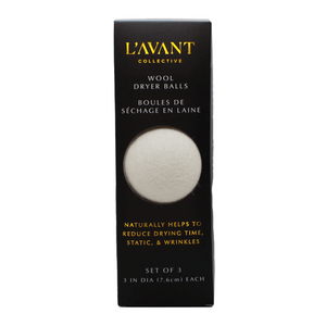Black rectangular packaging showing a single white wool dryer ball through a window, labeled Wool Dryer Balls | L'AVANT Collective, promoting natural reduction of drying time, static, and wrinkles.