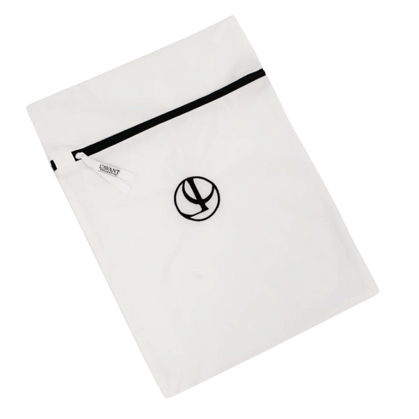 White mesh laundry bag with black zipper and logo detail, designed for delicate garment protection, part of the Mesh Laundry Bags Set of 2 | L'AVANT Collective.