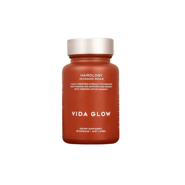Brown bottle of Hairology Capsules | VIDA GLOW dietary supplement with white cap, designed for advanced hair repair and promoting hair growth wellness.