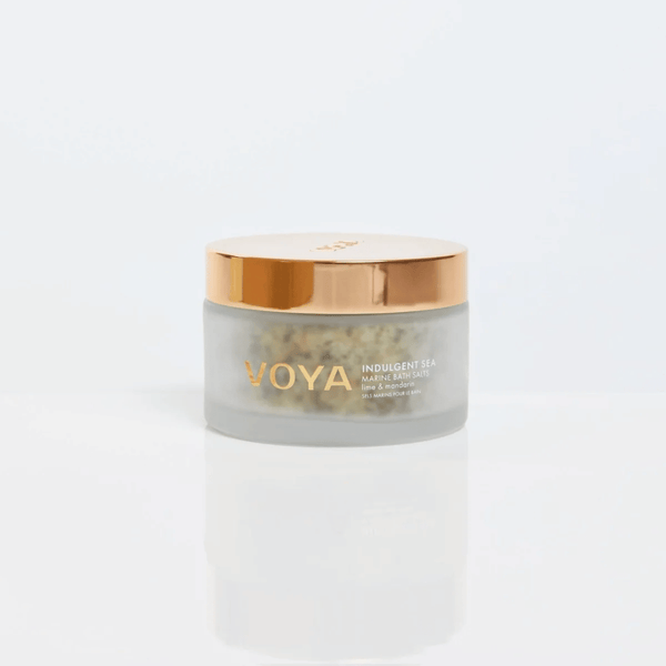 Jar of Indulgent Sea Marine Bath Salts | VOYA with a frosted glass body and shiny gold lid, designed for skincare and body care wellness routines.