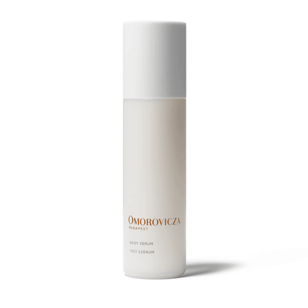 Minimalist white bottle of Body Serum | Omorovicza with clean design and gold lettering, displayed on a white background for skincare and body care.