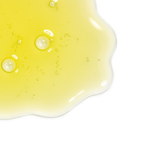 Close-up of a smooth, yellow serum texture with bubbles representing Vital C Serum 20% w/ Ellagi-C & Resveratrol Concentrate | Skin Fitness Therapy for skincare use.