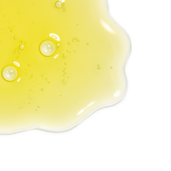Close-up of a smooth, yellow serum texture with bubbles representing Vital C Serum 20% w/ Ellagi-C & Resveratrol Concentrate | Skin Fitness Therapy for skincare use.