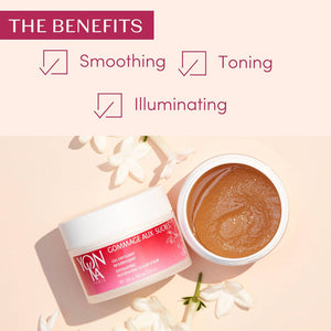 Open jar of Gommage Sucre Relax: Jasmine Sugar Scrub – Exfoliating, Nourishing Sugar Scrub I Yon-Ka Paris with jasmine flowers, highlighting its smoothing, toning, and illuminating benefits for skincare.