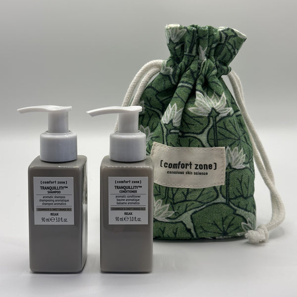 Tranquillity Hair Kit | [ comfort zone ] featuring matching shampoo and conditioner bottles with a green floral drawstring pouch for an elegant skincare and wellness experience.
