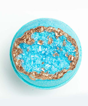 Top view of a vibrant blue Amazonite – Geode Bath Bomb | Latika featuring a textured crystal-like center with a metallic copper rim, designed for luxurious skincare and wellness.