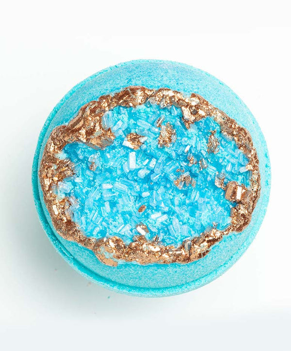 Top view of a vibrant blue Amazonite – Geode Bath Bomb | Latika featuring a textured crystal-like center with a metallic copper rim, designed for luxurious skincare and wellness.