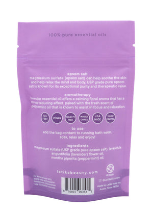 Back view of Bath Soak | Latika packaging in lavender color detailing ingredients like magnesium sulfate, lavender, and peppermint essential oils, with usage instructions and wellness benefits.