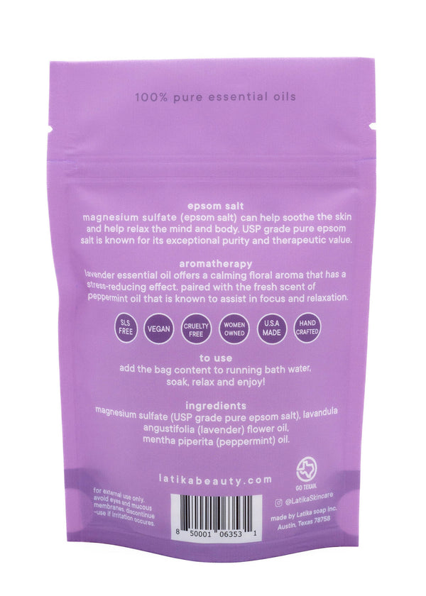 Back view of Bath Soak | Latika packaging in lavender color detailing ingredients like magnesium sulfate, lavender, and peppermint essential oils, with usage instructions and wellness benefits.