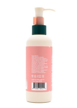 Back view of a skincare bottle featuring ingredients list and cruelty-free label for Rose (wildflower) Hand + Body Cream | Latika with a pump dispenser.