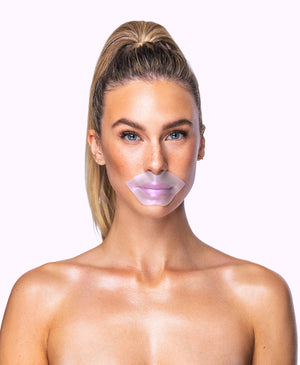 Woman with a clear lavender lip mask applied, showcasing the Diamond Radiance Collagen Lip Mask | KNESKO for skincare and lip hydration.