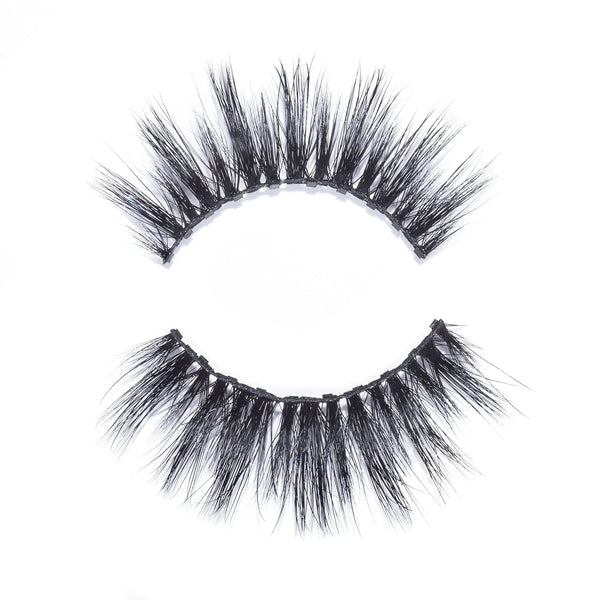 Close-up of a pair of dramatic, voluminous false eyelashes with a wispy design isolated on white background featuring Dolly Lash | Moxielash.