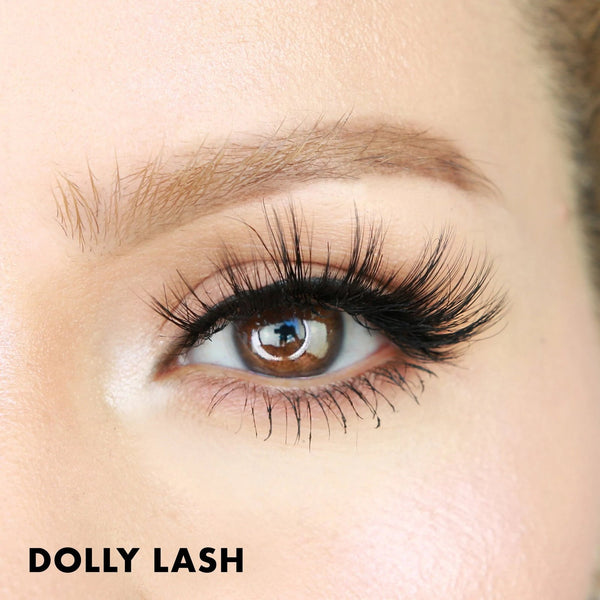 Close-up of a brown eye with long, voluminous eyelashes featuring Dolly Lash | Moxielash, showcasing enhanced lash length and fullness for a dramatic beauty look.