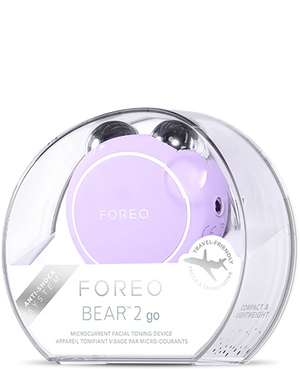 BEAR™ 2 Go | FOREO lavender microcurrent facial toning device in a transparent travel-friendly case, promoting skincare and wellness recovery.