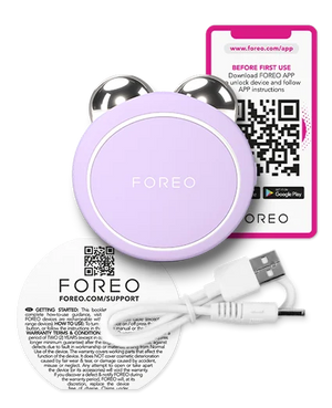 BEAR™ 2 Go | FOREO in lavender with metallic massage spheres, USB charging cable, and a QR code instruction card, designed for skincare and body care wellness.