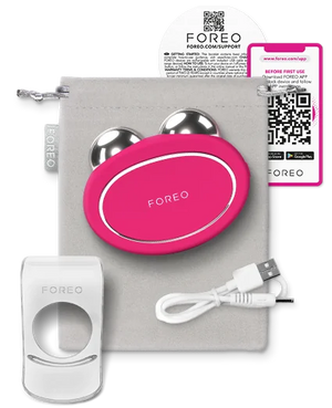 BEAR™ 2 | FOREO facial toning device in bright pink with dual metallic spheres, charging cable, holder, and a soft storage pouch.