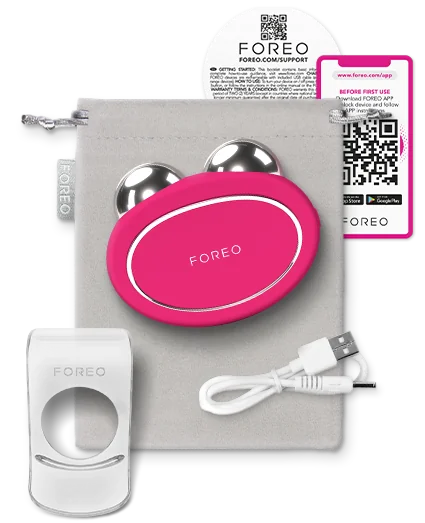 BEAR™ 2 | FOREO facial toning device in bright pink with dual metallic spheres, charging cable, holder, and a soft storage pouch.