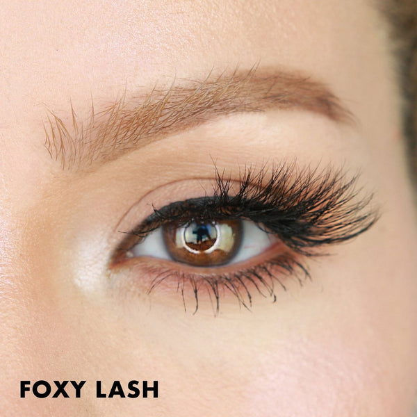 Close-up of a brown eye with long, thick, and voluminous eyelash extensions, showcasing the dramatic effect of Foxy Lash | Moxielash for enhanced eye beauty.