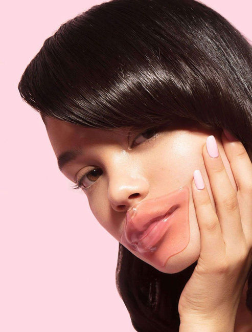 Close-up of a woman applying a Hydrating Reusable Lip Mask | Dreambox Beauty on her lips, showcasing smooth, moisturized skin and self-care in skincare routine.