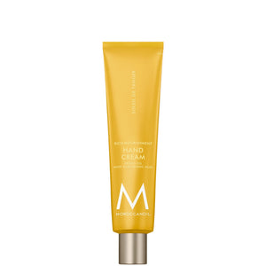 Tube of Hand Cream | Moroccanoil in yellow packaging with silver cap, designed for skincare and body care with nourishing ingredients and hyaluronic acid.