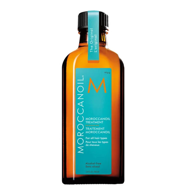 Amber glass bottle of Moroccanoil Treatment | Moroccanoil with turquoise label, designed for hair care and suitable for all hair types.