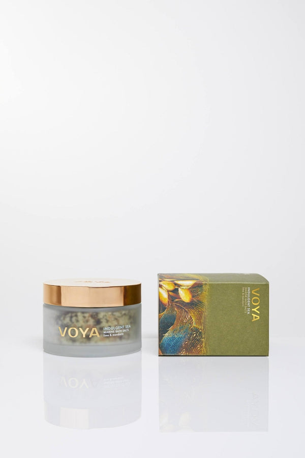 Indulgent Sea Marine Bath Salts | VOYA in a clear jar with gold lid alongside its green artistic packaging, highlighting luxurious skincare and wellness body care.