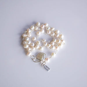 It's A Wrap Triple Pearl Bracelet | Liv & B featuring multiple strands of white freshwater pearls linked with silver chain and a decorative silver toggle clasp.