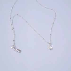 Diamond Slice Sterling Silver Necklace | Liv & B featuring a delicate sterling silver chain with a small diamond slice pendant and adjustable clasp.