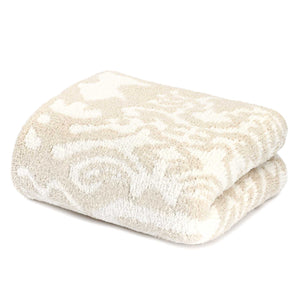 Soft folded beige and cream patterned throw blanket with a plush texture, featuring Throws - Damask - Chenilla Cloud™ | Kashwére design.