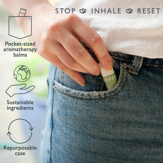 Hand placing a Wellbeing Ritual Aromatherapy Mini Tin | Scentered into a blue jeans pocket, with icons highlighting pocket-sized aromatherapy balms, sustainable ingredients, and a repurposable case.