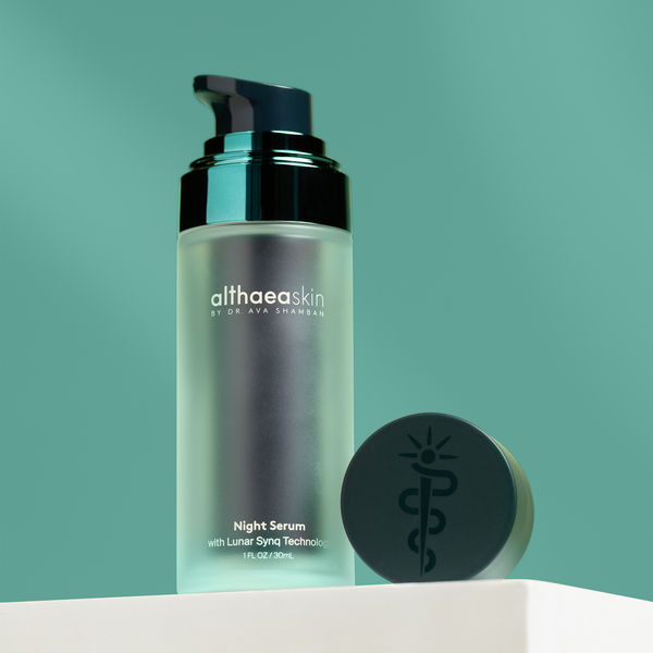Night Serum | Althaea Skin in a frosted glass bottle with a black pump and matching black cap, displayed against a green background for skincare and wellness.