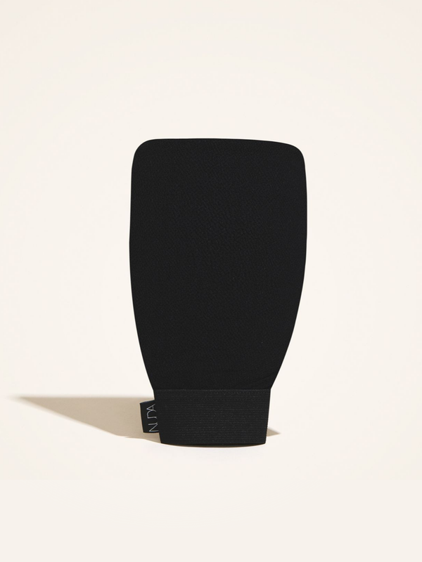 Exfoliating Mitt | NUDA in black with a textured surface designed for effective skincare and body care exfoliation.