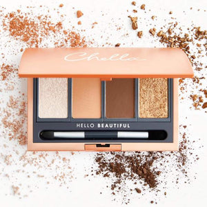 La Vie Neutral Eyeshadow Palette | Chella featuring four warm neutral shades with a dual-ended brush, displayed with scattered eyeshadow powders around the case.