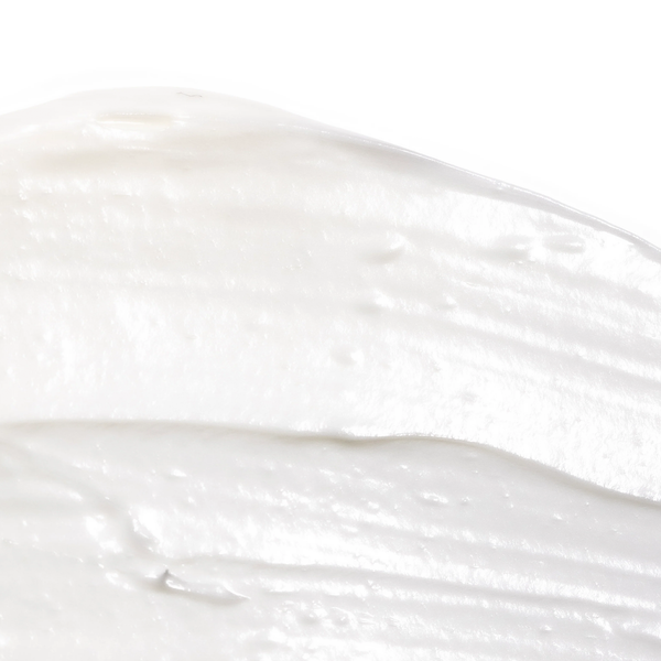 Close-up texture of creamy white skincare product representing Tone-n-Tighten Eye Cream with Instalift | Skin Fitness Therapy, emphasizing smooth and rich consistency.