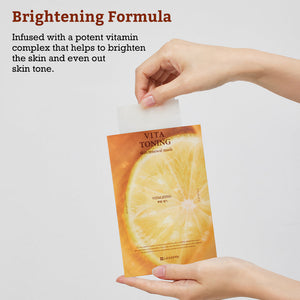 Hands holding a Leaders Skin Renewal Mask Vita Toning | Leaders packet with a lemon design, highlighting a brightening formula that evens skin tone and revitalizes skin with vitamins.