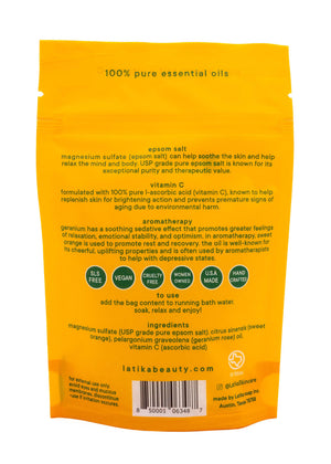 Back of bright yellow packaging for Bath Soak | Latika featuring product benefits, ingredients including magnesium sulfate and vitamin C, and usage instructions for skincare and wellness.