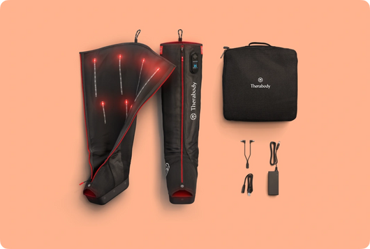 JetBoots PRO Plus | Therabody displayed with one boot partially unzipped showing interior design, along with power adapter, cords, and black carrying case for wellness recovery use.