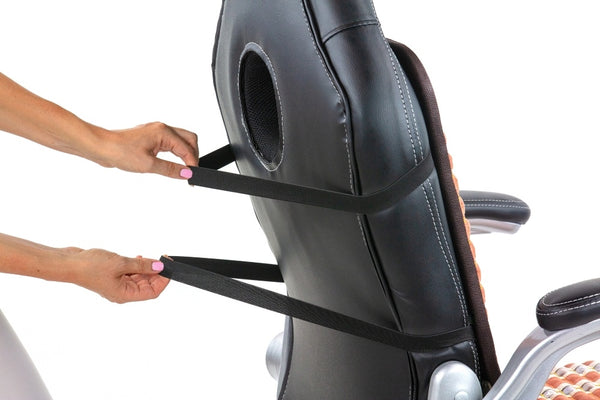 Person securing the TAO-Mat® Chair 4018 Firm - PEMF InfraMat Pro® | HealthyLine to a black office chair by fastening adjustable straps around the chair backrest.