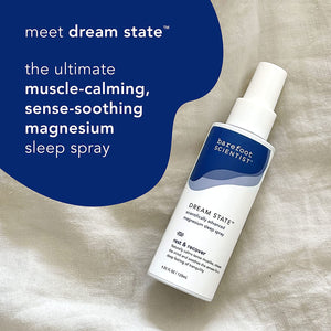 Bottle of DREAM STATE | Barefoot Scientist magnesium sleep spray on a soft fabric background, promoting muscle-calming and sense-soothing benefits for restful recovery.