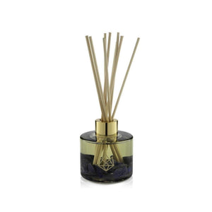 Calm Reed Diffuser | Aluminate Life with natural wooden reeds in a translucent smoky glass container accented with gold detailing, offering a serene and elegant wellness aroma experience.