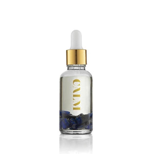 Clear glass dropper bottle with gold cap containing liquid and blue stones, labeled Calm Essential Oil Vial | Aluminate Life for wellness and relaxation use.