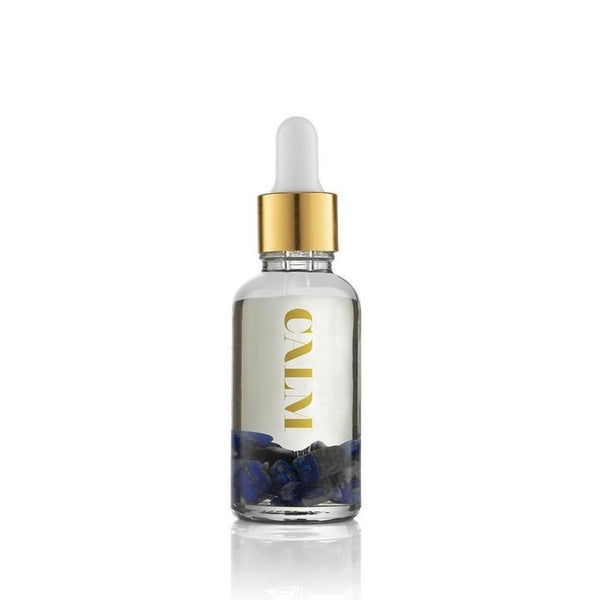 Clear glass dropper bottle with gold cap containing liquid and blue stones, labeled Calm Essential Oil Vial | Aluminate Life for wellness and relaxation use.