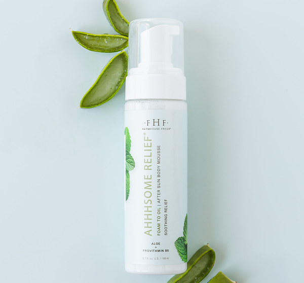 Ahhhsome Relief™ Foam-to-Oil After Sun Body Mousse | Farmhouse Fresh bottle with aloe vera leaves on a light background, highlighting soothing skincare and body care.