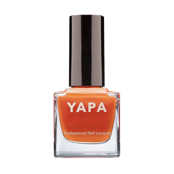 Bottle of Andrew Nail Lacquer | YAPA in a vibrant orange shade with a sleek black cap, designed for professional nail care and polish.