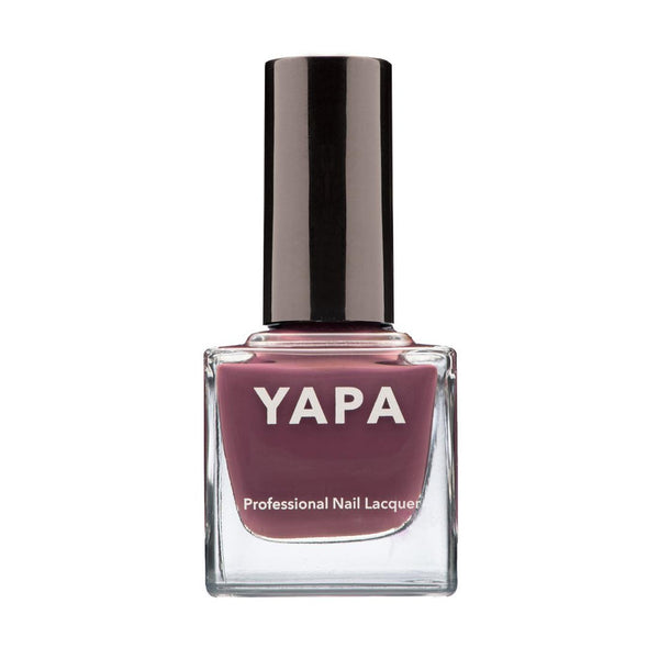 A close-up of a mauve-toned nail polish bottle labeled Ava Nail Lacquer | YAPA with a sleek black cap, highlighting a professional and elegant beauty product.