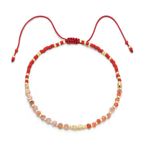 Japanese Handmade Bead Bracelets | Live Love Spa featuring a delicate adjustable red cord with alternating red, pink, and gold beads, ideal for wellness and style.