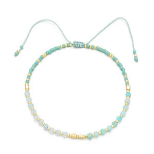 Delicate turquoise and gold beaded bracelet with adjustable cord, showcasing artisanal craftsmanship in Japanese Handmade Bead Bracelets | Live Love Spa.