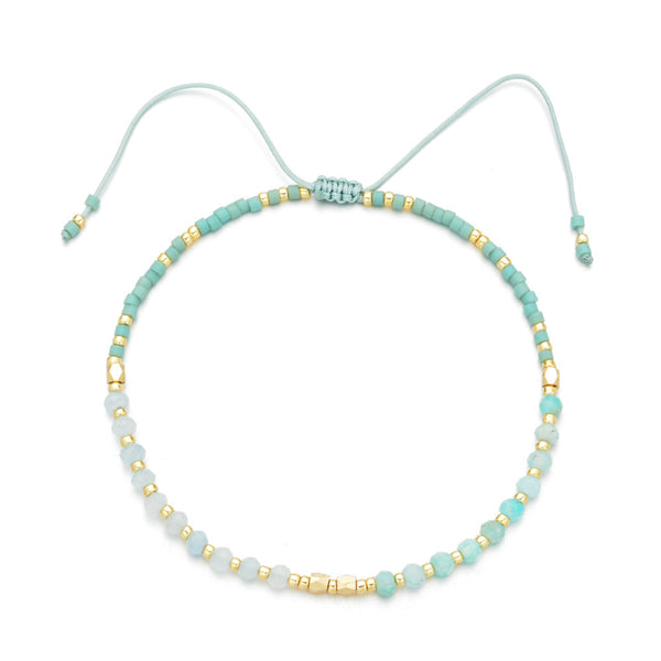 Delicate turquoise and gold beaded bracelet with adjustable cord, showcasing artisanal craftsmanship in Japanese Handmade Bead Bracelets | Live Love Spa.